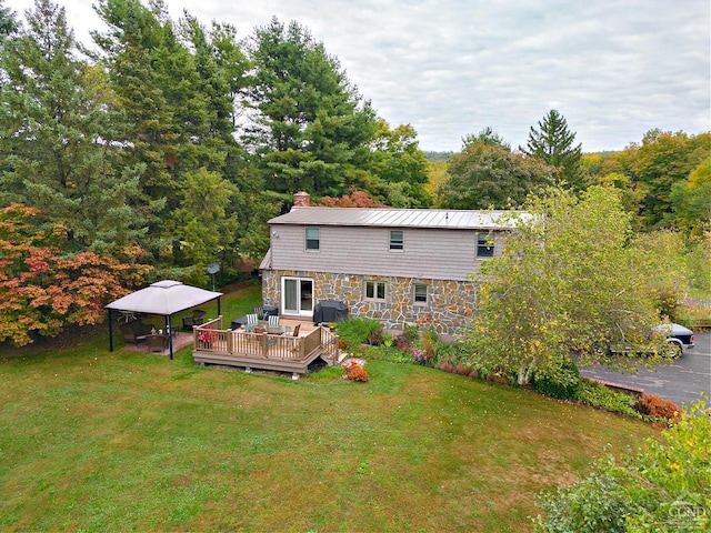 back of house featuring a yard and a deck