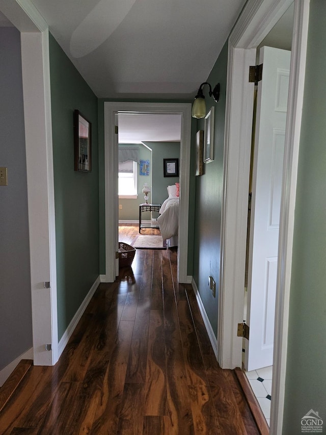 hall with dark wood-type flooring