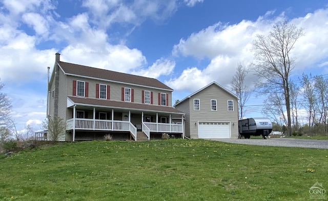 colonial home with a garage, covered porch, and a front lawn