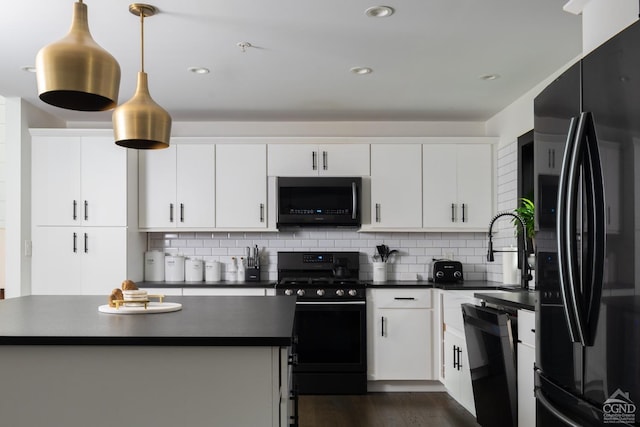 kitchen featuring white cabinets, dark countertops, decorative backsplash, and black appliances