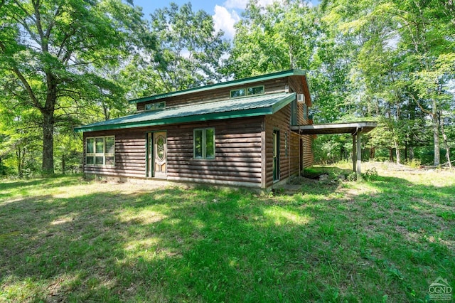 view of outbuilding featuring a lawn