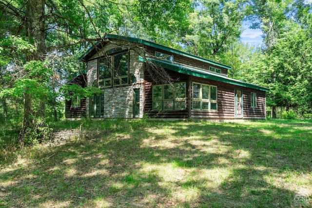 view of side of home featuring a yard