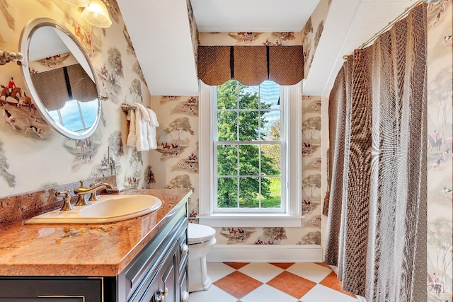 bathroom featuring vanity, a shower with shower curtain, baseboards, tile patterned floors, and toilet