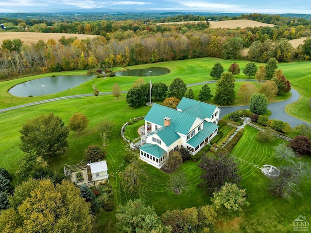 drone / aerial view with a water view and golf course view