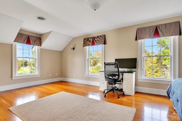 home office with visible vents, baseboards, and light wood-style flooring