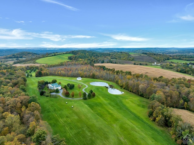 birds eye view of property with golf course view and a view of trees