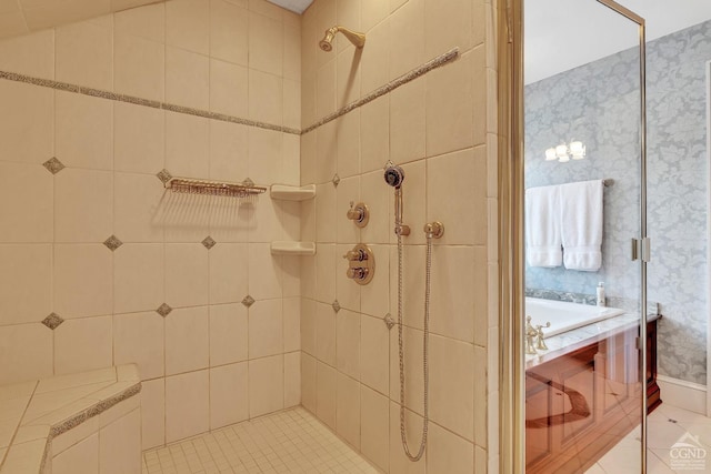 full bathroom with wallpapered walls, tile patterned floors, a bath, and a tile shower