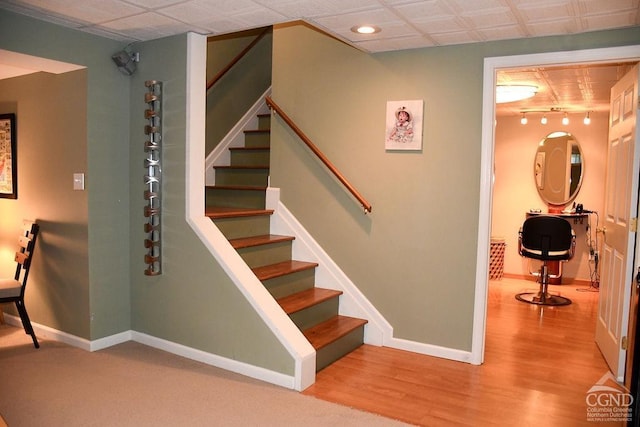 stairway featuring baseboards, recessed lighting, and wood finished floors