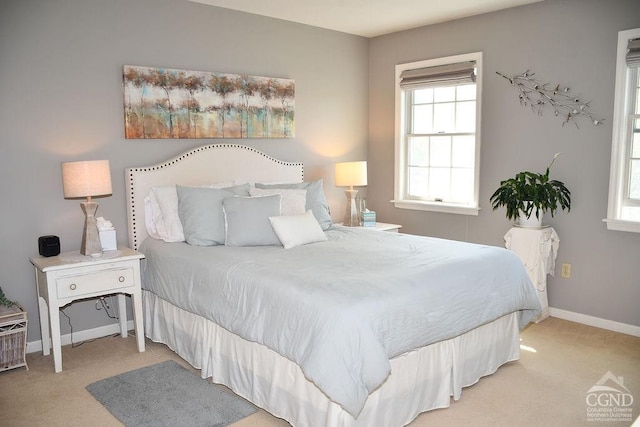 carpeted bedroom featuring baseboards