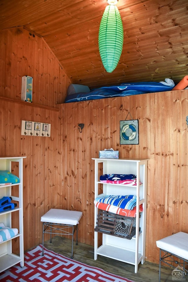 bedroom with wooden ceiling, wood walls, and lofted ceiling