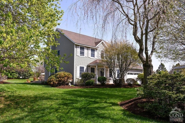 view of front facade featuring a garage and a front lawn
