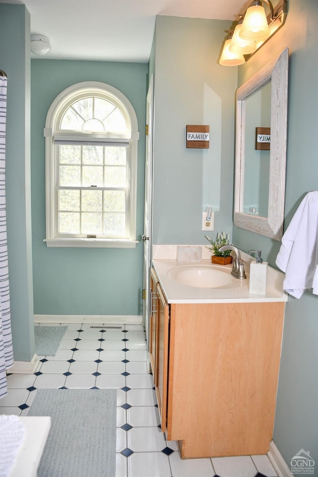bathroom with baseboards and vanity
