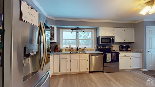 kitchen featuring sink, light hardwood / wood-style flooring, stainless steel appliances, ornamental molding, and white cabinets