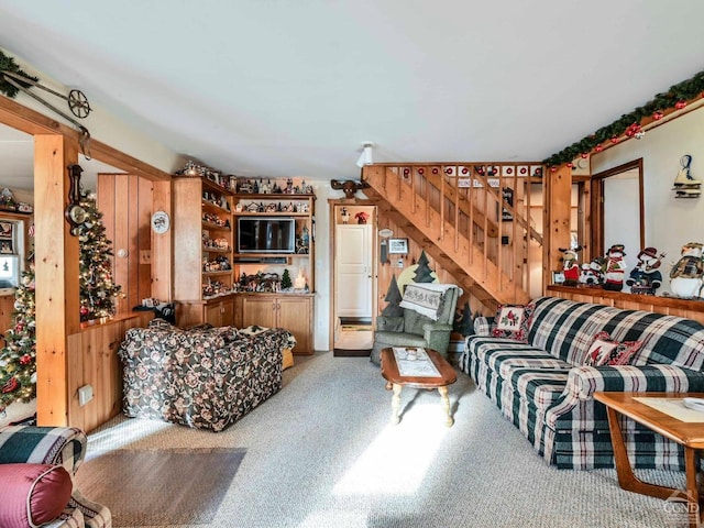 living room with carpet flooring and wooden walls