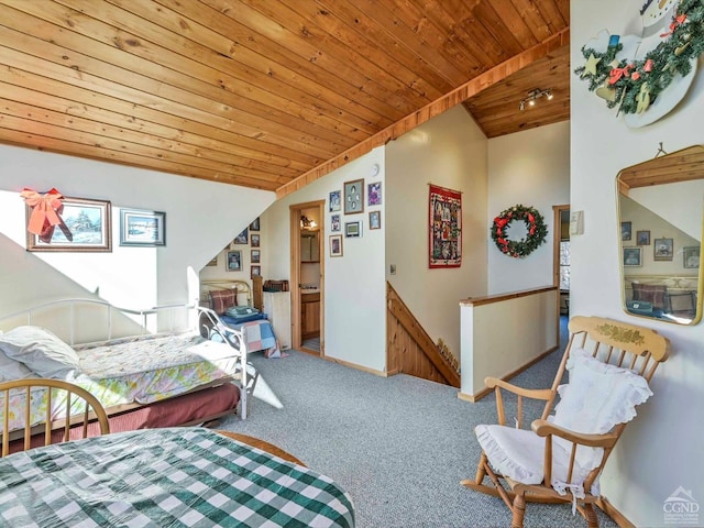 bedroom featuring carpet flooring, ensuite bath, wooden ceiling, and lofted ceiling