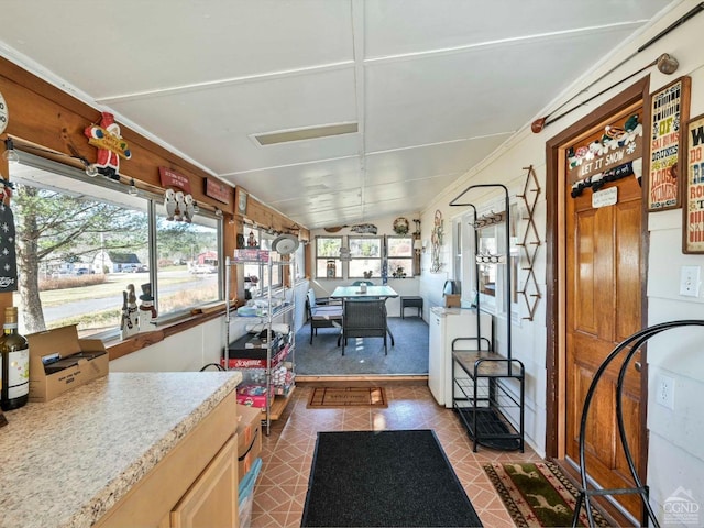 sunroom / solarium featuring vaulted ceiling