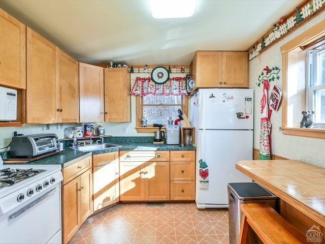 kitchen featuring white appliances and sink