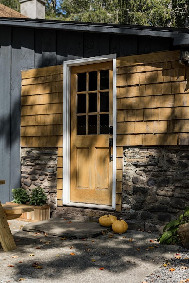property entrance with stone siding