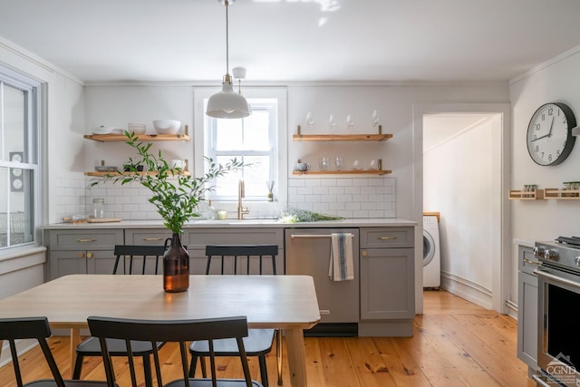 kitchen featuring stainless steel appliances, gray cabinets, open shelves, and washer / dryer