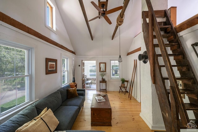 living room with light wood finished floors, stairs, high vaulted ceiling, and a ceiling fan