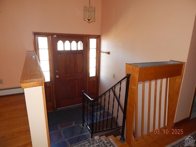 entryway featuring baseboard heating and wood finished floors