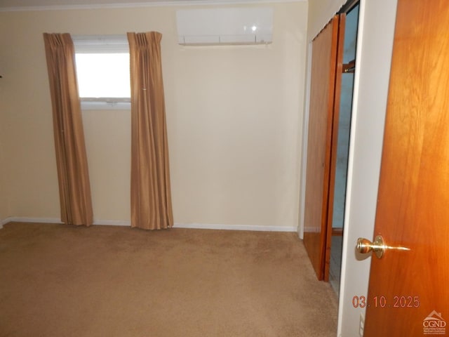 hall with baseboards, carpet floors, and a wall unit AC