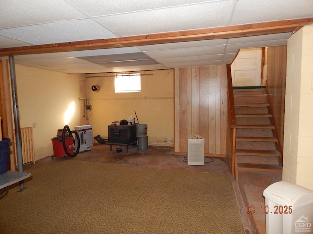 basement with a drop ceiling, stairs, and carpet floors