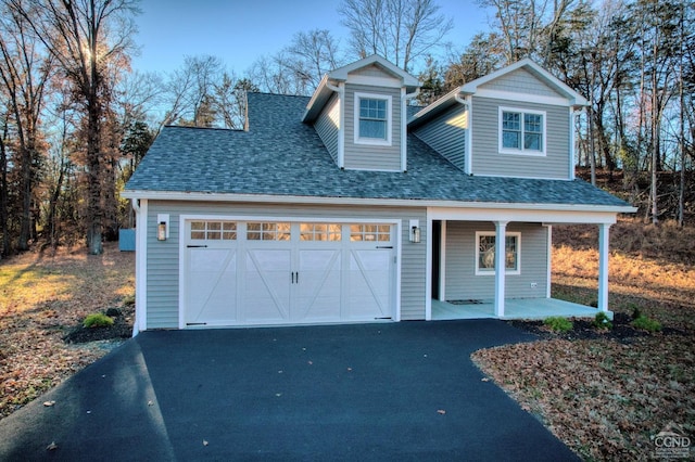 view of front of house with a porch and a garage