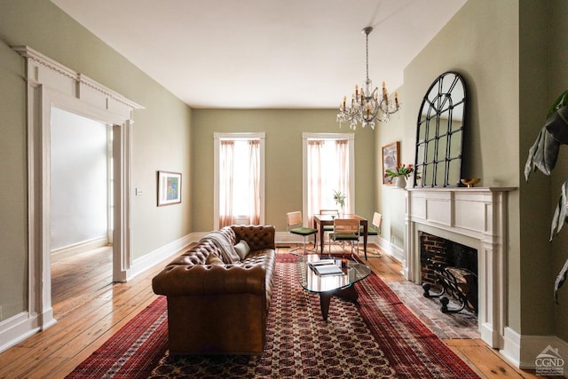 living room featuring an inviting chandelier and hardwood / wood-style flooring