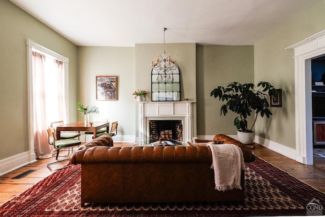 living room with hardwood / wood-style floors and a notable chandelier