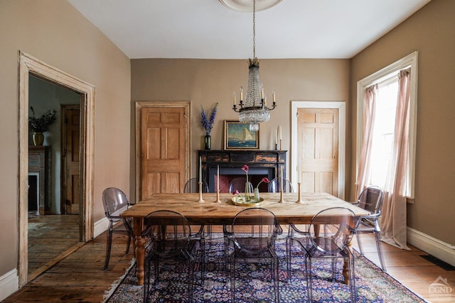 dining room featuring hardwood / wood-style flooring and an inviting chandelier