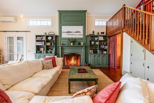 living room featuring wood-type flooring, an AC wall unit, and french doors