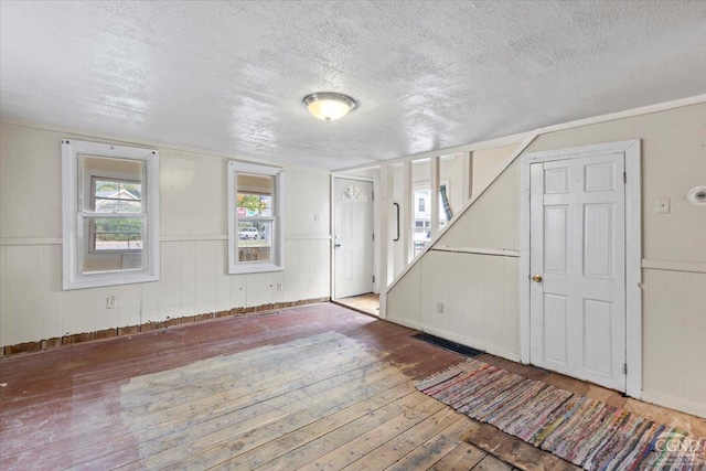 foyer with a textured ceiling and light wood-type flooring