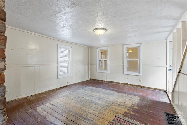 empty room featuring hardwood / wood-style floors and a textured ceiling