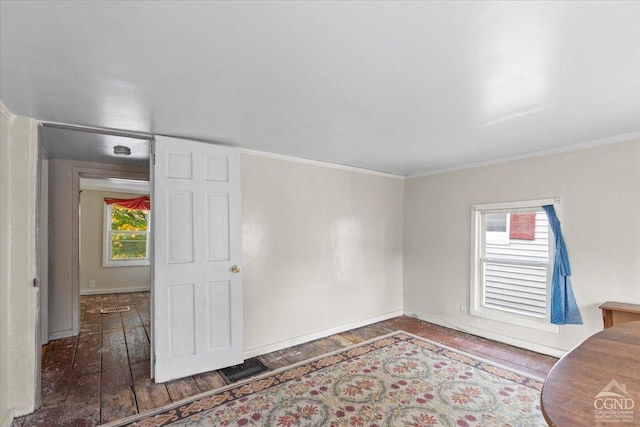 unfurnished living room with dark hardwood / wood-style flooring and ornamental molding