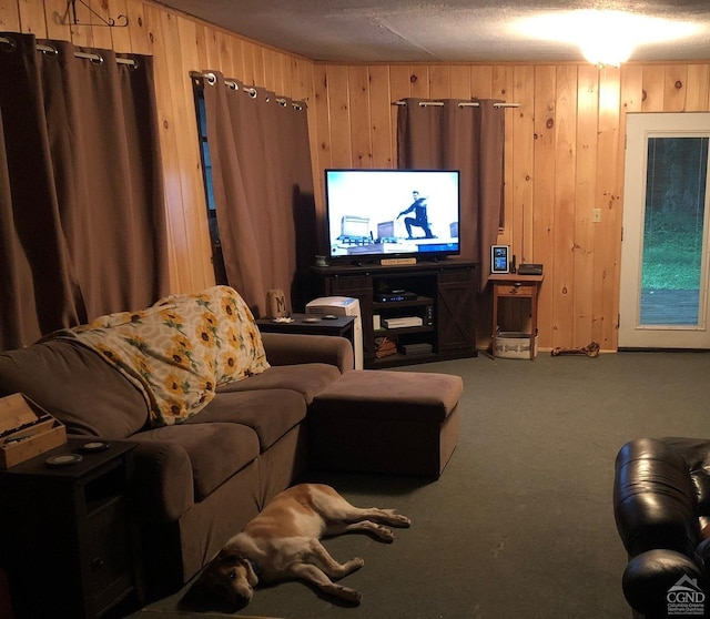 carpeted living room featuring wooden walls and a textured ceiling