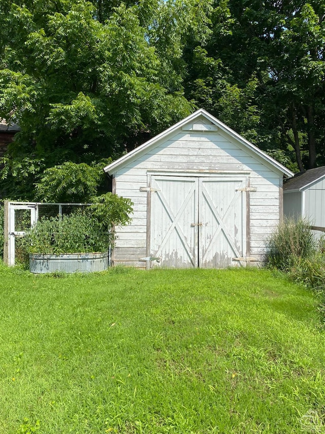 view of outbuilding with a lawn