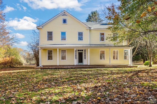 view of front of property featuring covered porch and a front yard