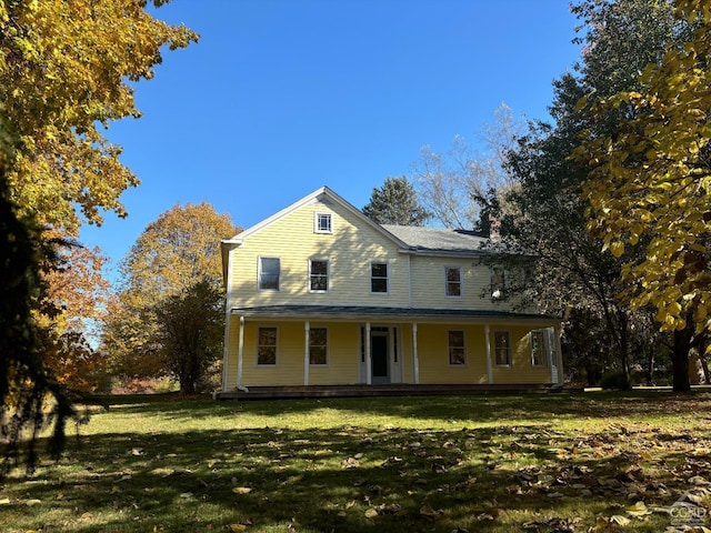 farmhouse-style home with a front lawn