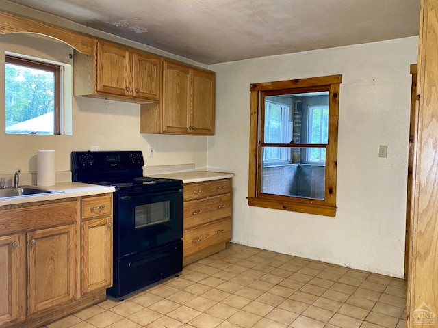 kitchen featuring sink and black / electric stove