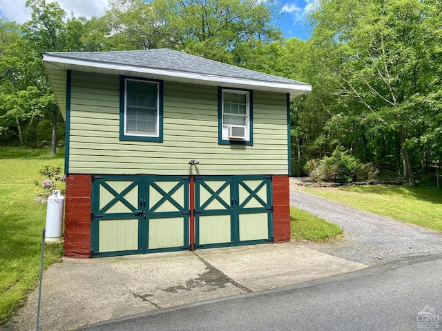 view of outbuilding with a yard and cooling unit