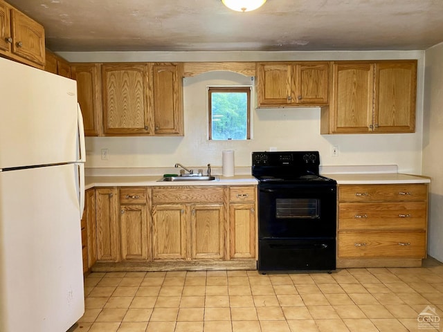 kitchen featuring white refrigerator, sink, and black / electric stove