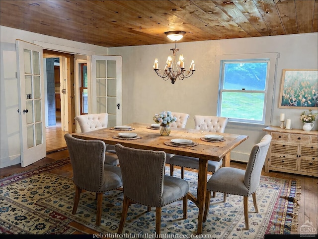 dining room with hardwood / wood-style flooring, wooden ceiling, a chandelier, and french doors