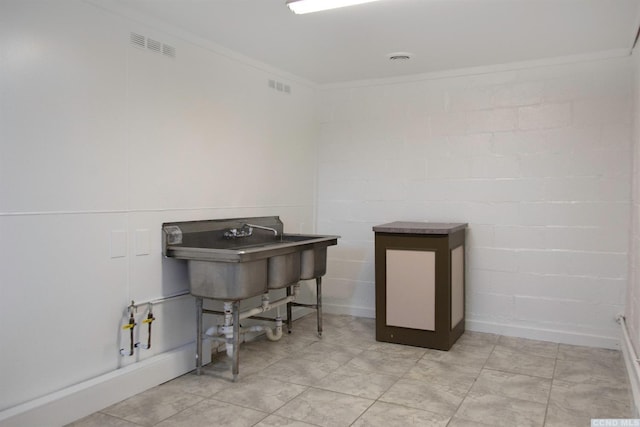 miscellaneous room featuring crown molding and sink