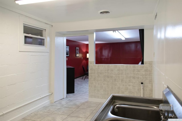 kitchen featuring sink and light tile patterned floors