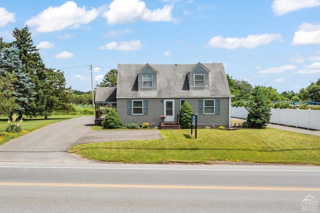 cape cod home featuring a front lawn