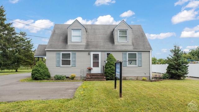 cape cod home with a front yard