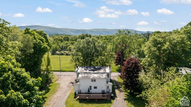 bird's eye view featuring a wooded view and a mountain view