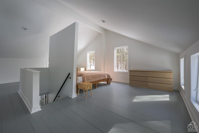 bedroom featuring lofted ceiling with beams, baseboards, and wood finished floors