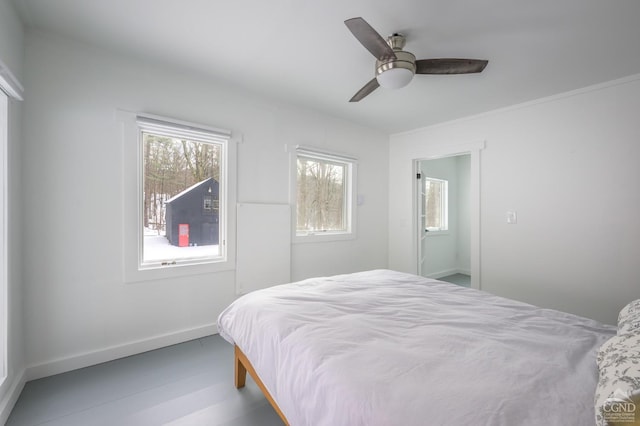 bedroom featuring a ceiling fan and baseboards